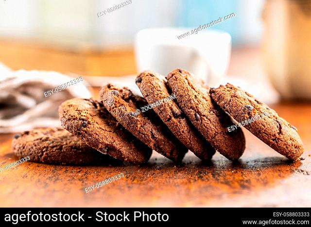 Tasty biscuits with chocolate. Sweet chocolate cookies on wooden table