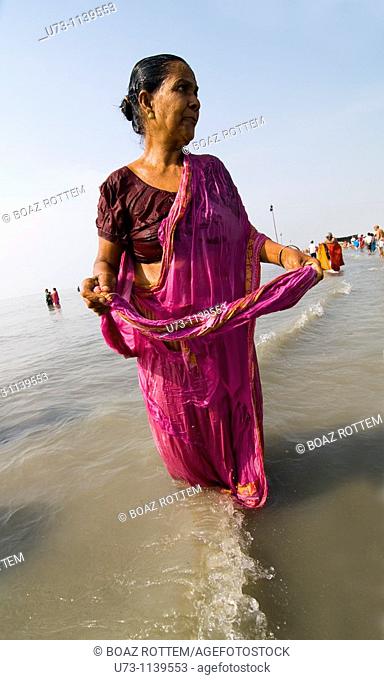 A woman bathing during the annual Gangasagar festival