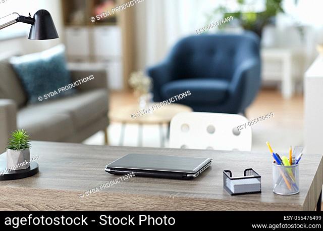 laptop and stationary on table at home office