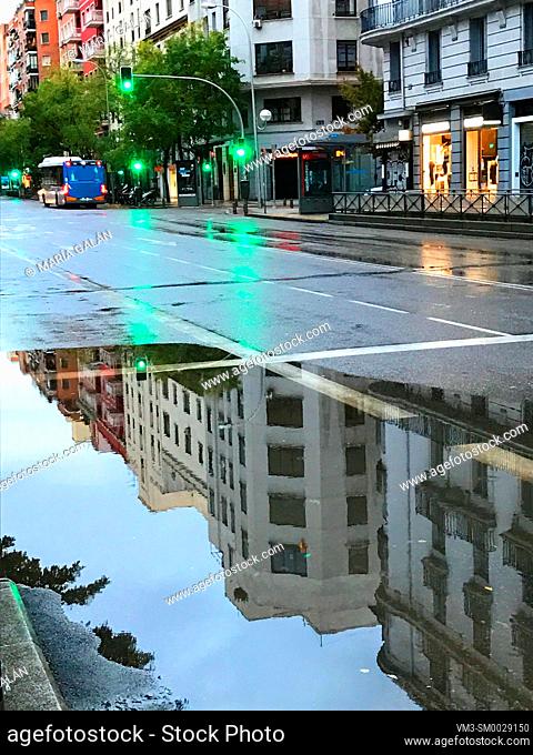 Rain puddle in Narvaez street. Madrid, Spain