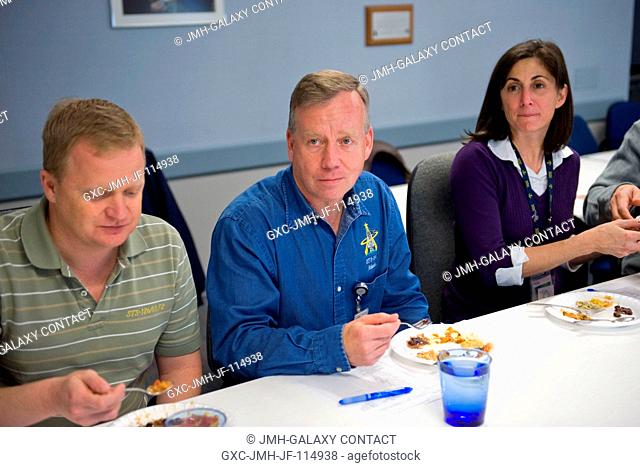 NASA astronauts Steve Lindsey (center), STS-133 commander; Eric Boe, pilot; and Nicole Stott, mission specialist, are pictured during a food tasting session in...
