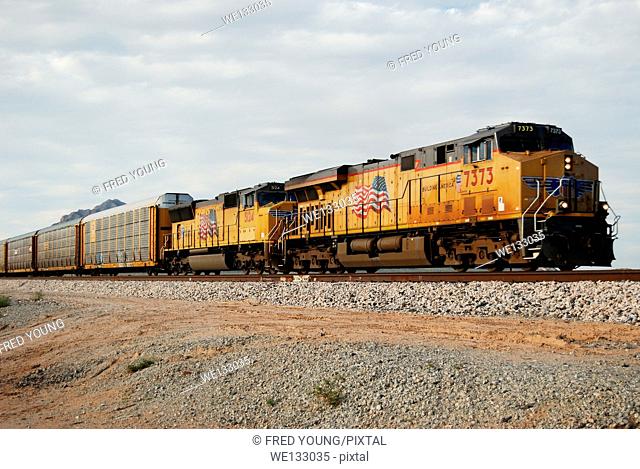 Picacho, AZ, USA - October 18, 2014: An approaching diesel locomotive pulling boxcars