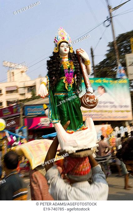 Sarasvati (Female Hindu God) idol being carried through street, Kolkatta (Calcutta). West Bengal, India