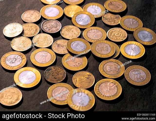 Heap of Gold Colored Indian Rupee Coin currency on rustic floor. Full Frame. High Angle View. Business Finance and financial Investment Background
