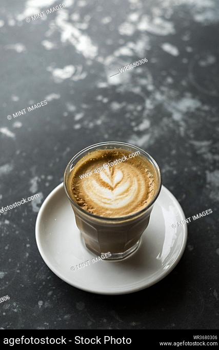 High angle close up of a cappuccino on a black marble table