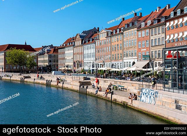 Copenhagen, Denmark - September 2, 2021: People enjoying a sunny day at Slotsholmen canal and Gammel Strand street