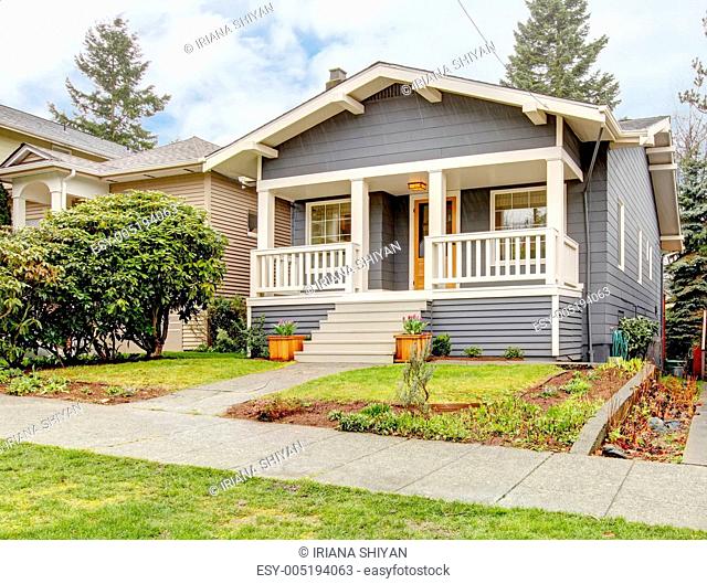 Grey craftsman style house with white porch