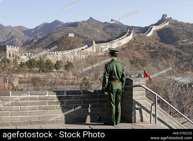 A soldier guarding tourists on the Great Wall of China. People's Republic of China