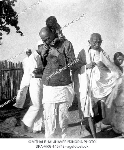 Mahadev Desai , carrying a child on his shoulders , Mahatma Gandhi and others at Sevagram Ashram , 1940 NO MR