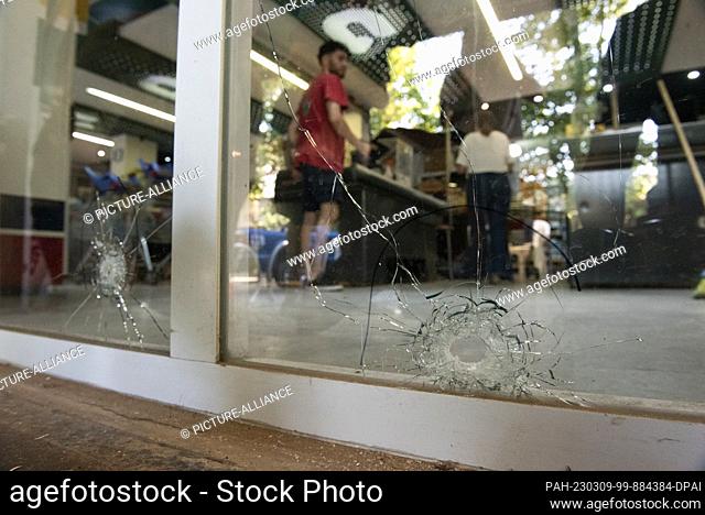 02 March 2023, Argentina, Rosario: Bullet holes can be seen on the facade of Messi's father-in-law's supermarket. Unknown people fired 14 shots at the store and...