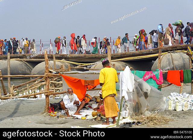 Pilgrims cross the Ganges on a makeshift pontoon bridge, Allahabad Kumbh Mela, world's largest religious gathering, Uttar Pradesh, India, Asia