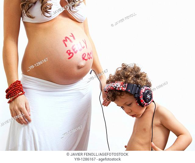 Pregnant woman and child listening to music with baby