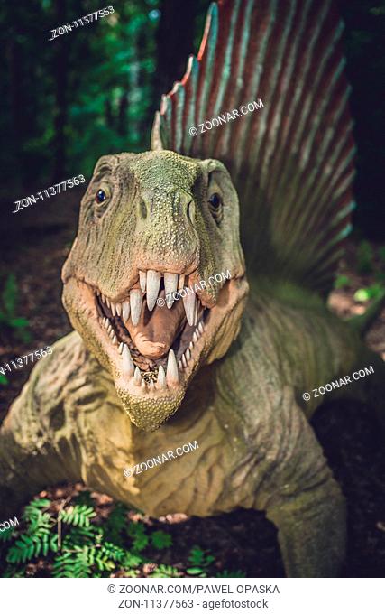 Solec Kujawski, Poland - August 2017 : Life sized spinosaurus dinosaur statue in a forest