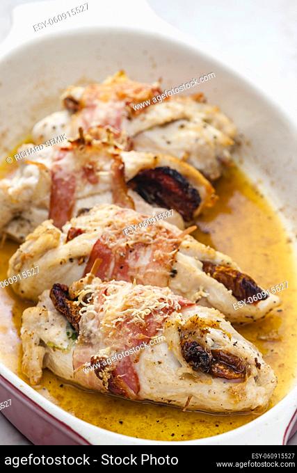 chicken rolls stuffed with dry tomatoes in bacon