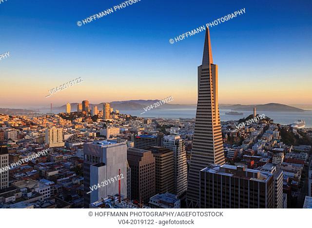 San Francisco skyline with Transamerica Pyramid with Golden Gate Bridge in the background at sunrise, California, USA