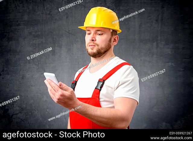 Portrait of a construction worker using smartphone