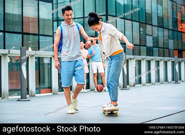 Handsome students goddaughter friend skateboarding