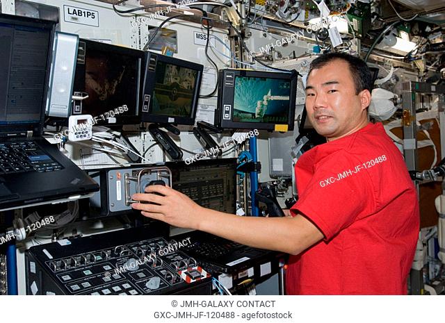 Japan Aerospace Exploration Agency (JAXA) astronaut Soichi Noguchi, Expedition 22 flight engineer, works controls at the Canadarm2 workstation in the Destiny...