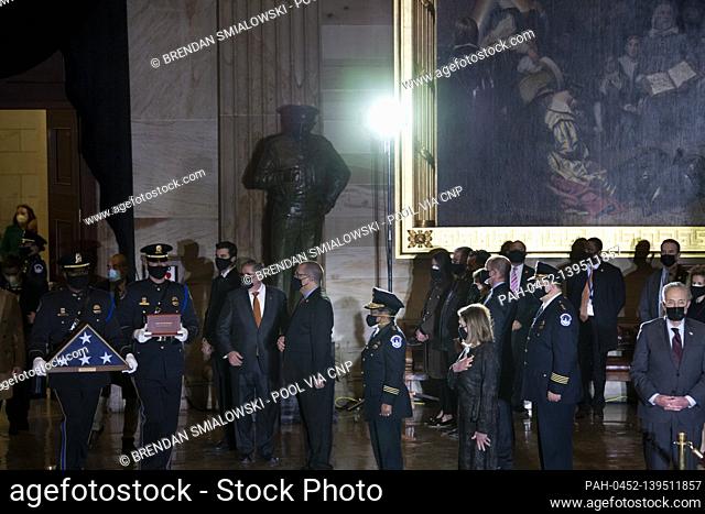 Capitol Police and lawmakers watch as the remains of Capitol Police officer Brian Sicknick arrive to lay in honor in the Rotunda of the US Capitol building...