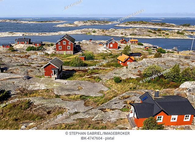 Red wooden houses on the rocky coast, Stockholm archipelago, Huvudskär archipelago island, Sweden