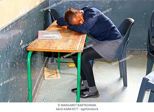 School girl sleeping in classroom, St Mark's School, Mbabane, Hhohho, Kingdom of Swaziland