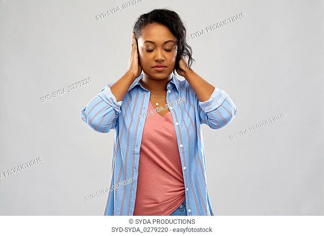 african american woman closing ears by hands