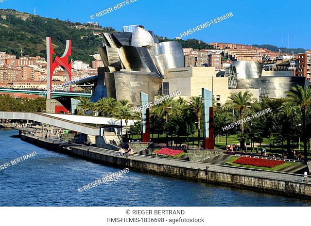 Spain, Basque Country Region, Vizcaya Province, Bilbao, the Guggenheim Museum designed by Frank Gehry and the Salve bridge with Les Arches Rouges artpiece by...