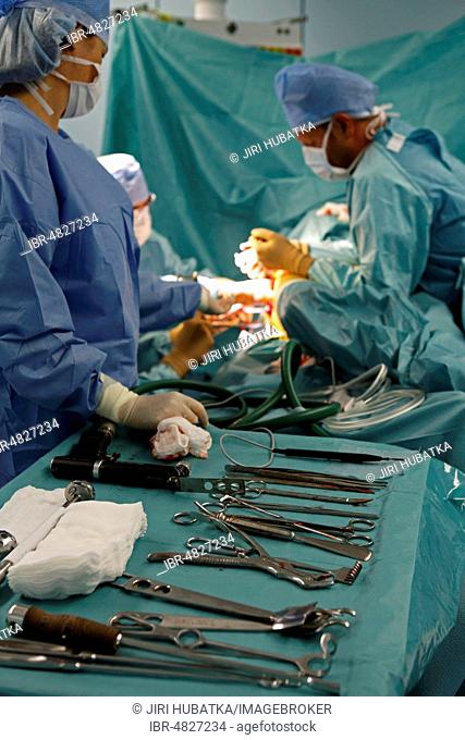 Surgeons during surgery, total hip replacement, medical equipment, surgery department, hospital, Czech Republic