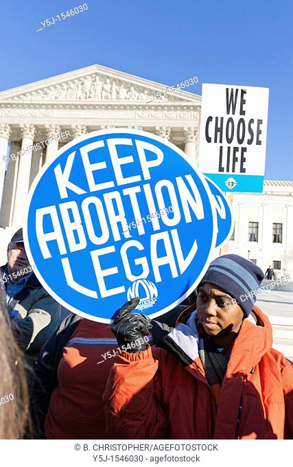 An African-American woman holding up a Pro-Choice sign in front of the Supreme Court