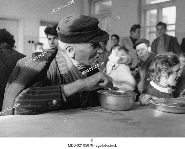 Istrian refugee eating in a public canteen. Trieste, 14th January 1956