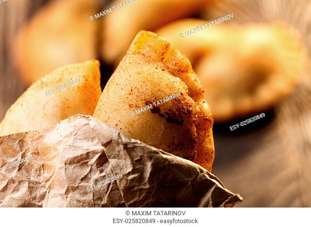 Fried colombian empanadas on wooden table. Savory stuffed patties also known as pastel, pate or pirozhki
