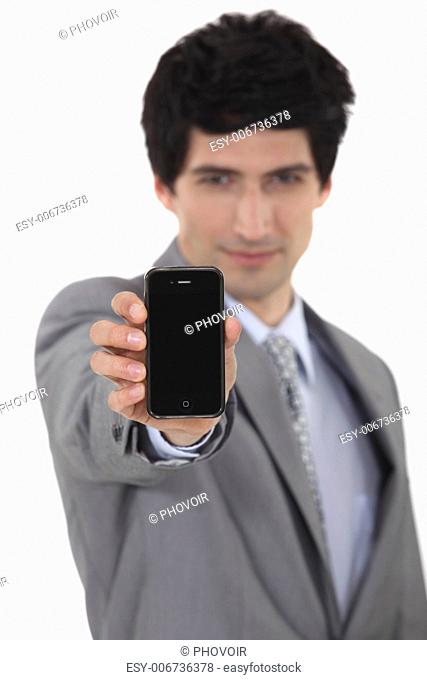 A businessman handing a phone