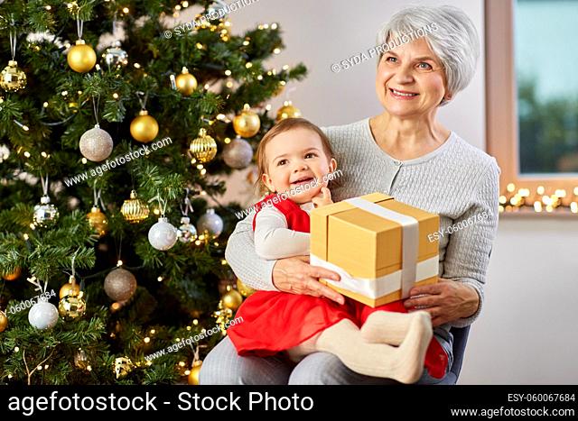 grandmother and baby girl with christmas gift