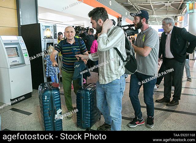 GEORGIA, TBILISI - MAY 19, 2023: Journalists approach a man at Shota Rustaveli Tbilisi International Airport where an Azimuth flight from Moscow arrives