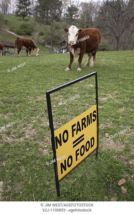 Dameron, West Virginia - A sign in a pasture on a small West Virginia farm promotes farming