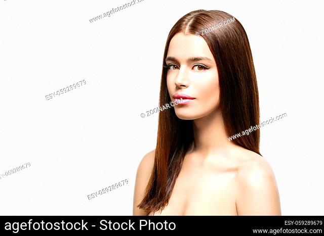 Beautiful young woman with healthy shiny straight hair. Beauty shot. Isolated over white background. Copy space