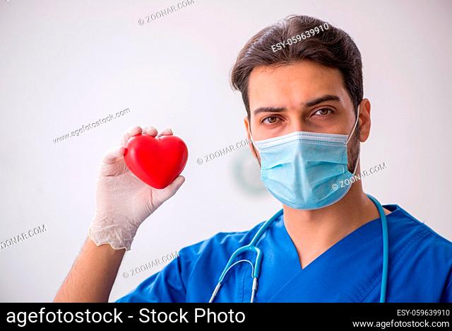Young doctor cardiologist working in the clinic during pandemic