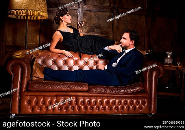 Passion, relations concept. Rich businessman ready to have elegant woman with red lips. Wealth, luxury concept. Romantic atmosphere