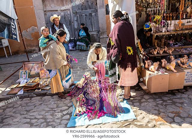 Mexican religious pilgrims and penitents purchase rope whips from a vendor outside the Sanctuary of Atotonilco, and important Catholic shrine in Atotonilco