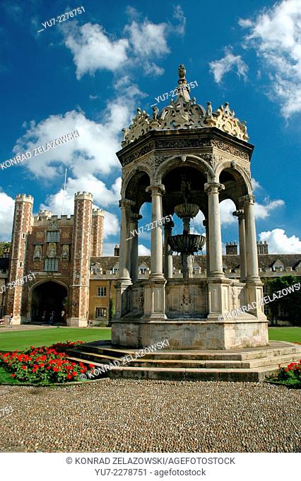 Fountain at Great Court with Great Gate on Trinity College in Cambridge, UK