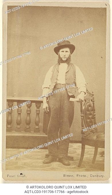 Unidentified man with long, bushy muttonchops wearing a hat, standing, with one arm on a chair back, Edward D. Ritton (American, 1823 - 1892), 1870–1880