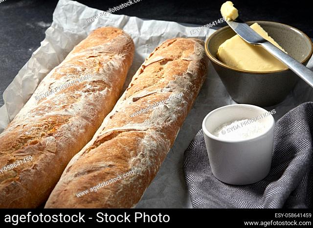 close up of bread, butter and knife on towel