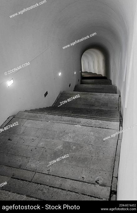 Light of the end of tunnel with ascending stairs