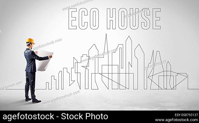 Businessman in hard hat holding blueprint with ECO HOUSE inscription, engineering and architecture concept