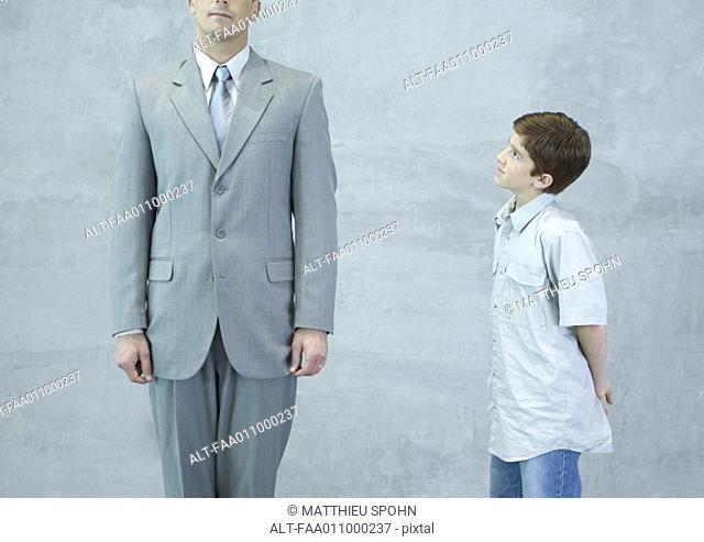 Boy looking up at businessman
