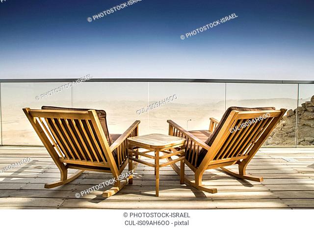 Empty deckchairs on wooden deck, Ramon Crater, Negev Desert, Israel