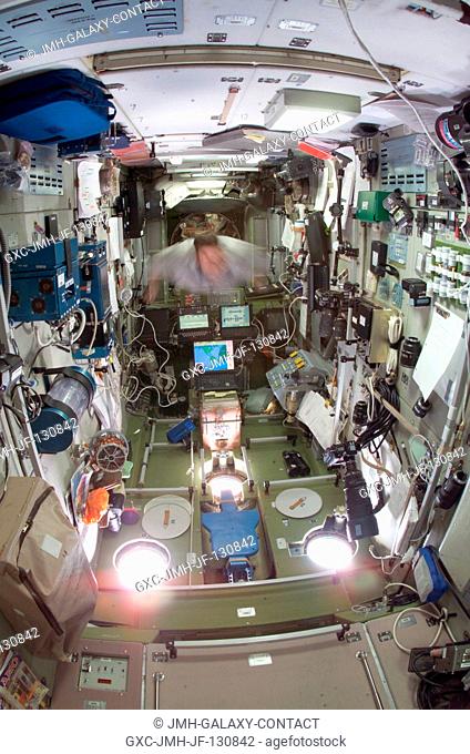 Cosmonaut Yuri I. Malenchenko, Expedition 7 commander, floats through the Zvezda Service Module on the International Space Station (ISS)