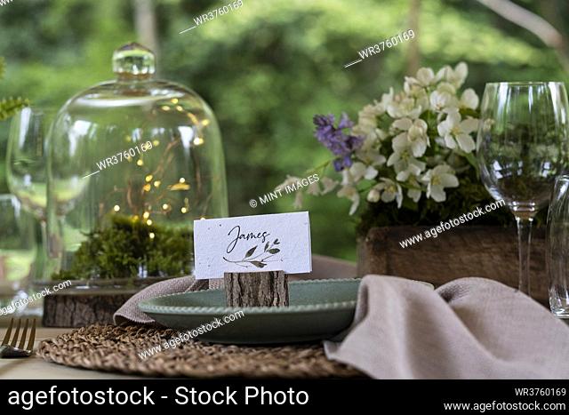 High angle close up of rustic place setting for a woodland naming ceremony