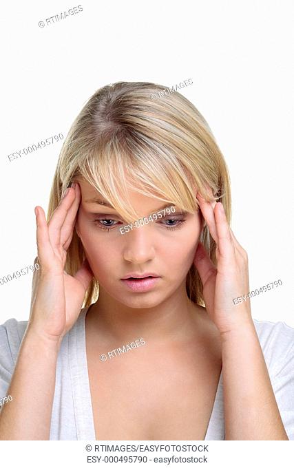 Blond woman with her hands on the side of her head in deep thought, white background