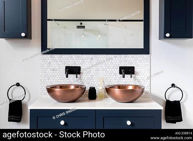Brass and copperware basins in the bathroom of a Victorian house in South West London, UK